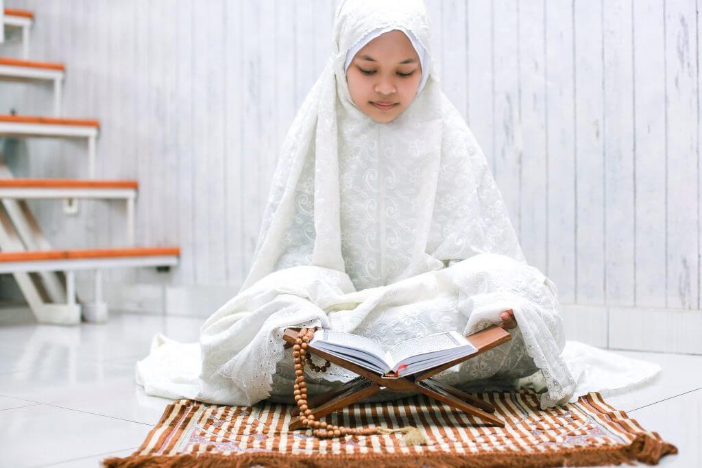 Muslim Girl Reading Quran on Jai Namaz